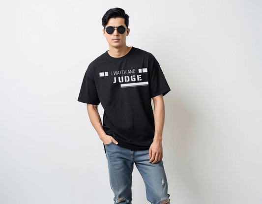 Men's black half sleeve oversized graphic printed t-shirt.